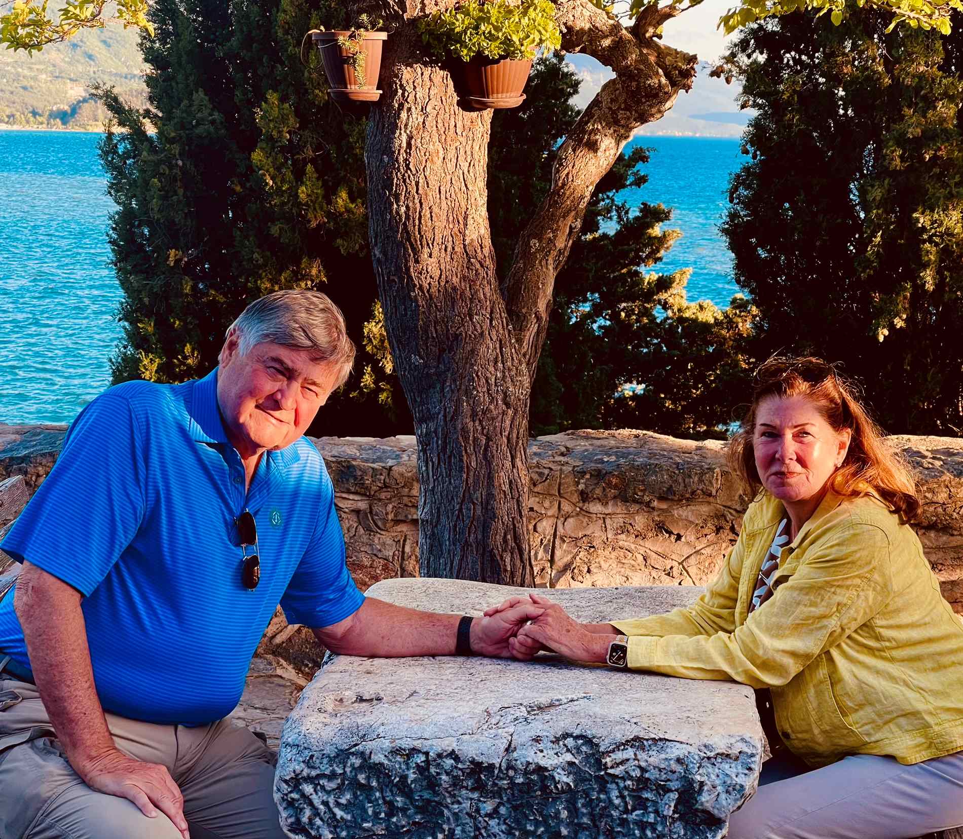 Cos and Robin sitting at a granite table on Lake Ohrid